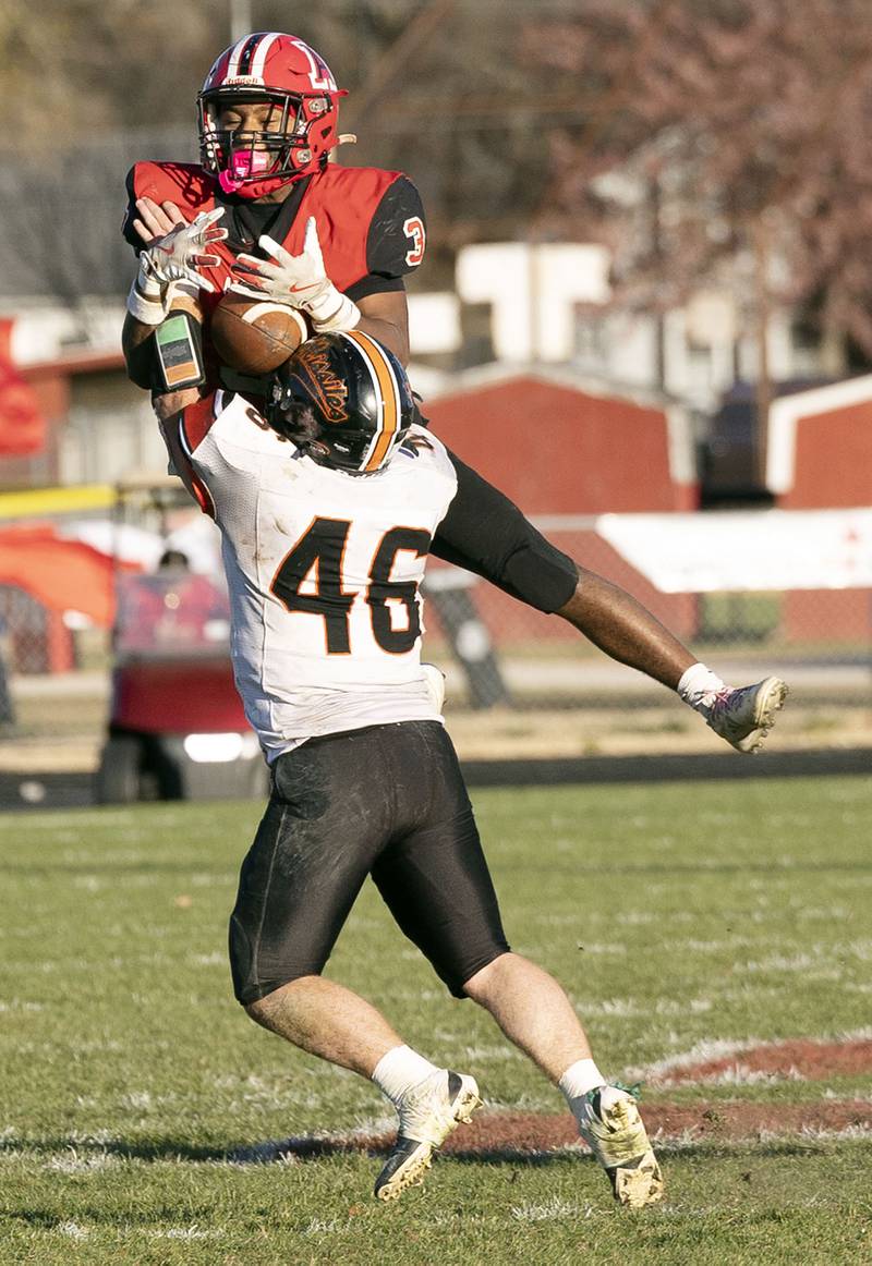 Amboy’s Cody Winn leaps to haul in a pass while defended by Milledgeville’s Spencer Nye Saturday, Nov. 15, 2025, in the 8-man football semifinal. Nye was called for pass interference.