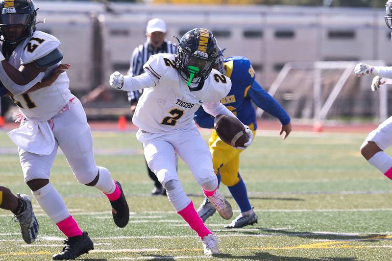 Joliet West’s Billy Bailey Jr. makes a cut upfield against Joliet Central on Saturday.