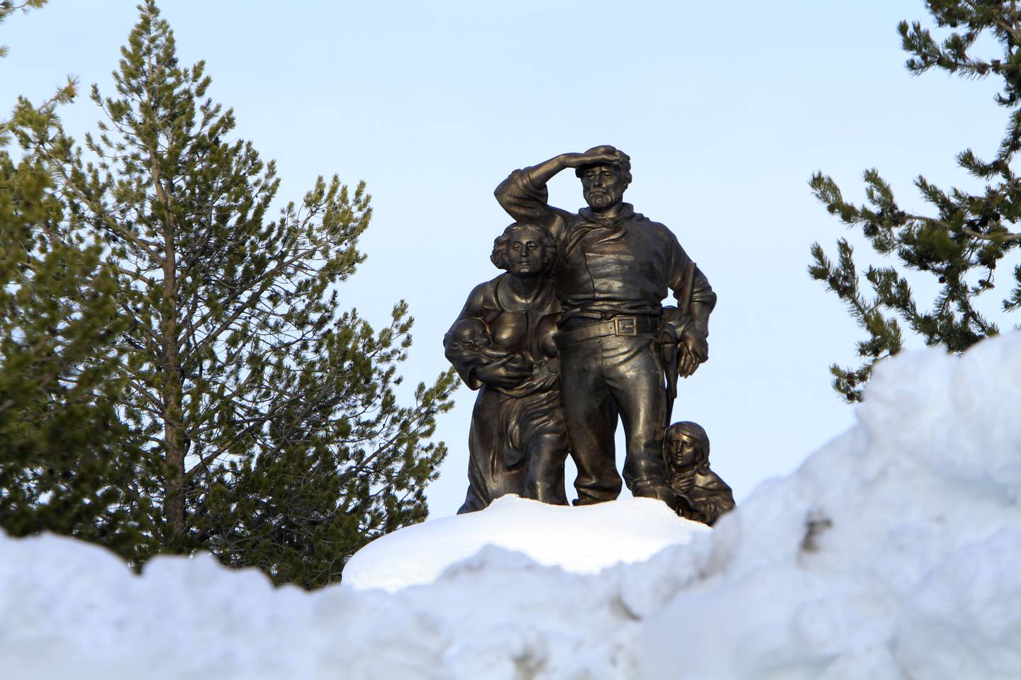 In this photo taken March 28, 2011, the Pioneer Memorial, dedicated to the Donner Party, is seen behind snow cleared from the parking lot at the Donner Memorial State Park at Truckee, Calif.