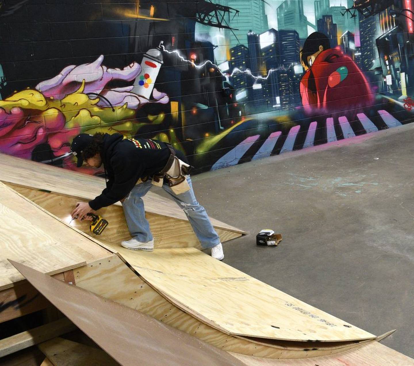Ian Nathan Jr. works on a ramp at his soon-to-open Syndicate Skate Park in Elgin. Graffiti artists from throughout the region painted the walls giving the park an urban vibe.