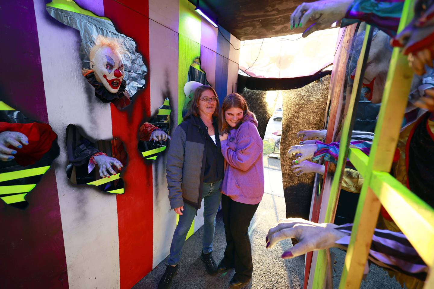 Melanie Schiffer, holds her daughter Clara, 18, tightly as the walk through part of their Halloween display in Downers Grove. The Schiffer family has been putting on an elaborate Halloween display for many years.