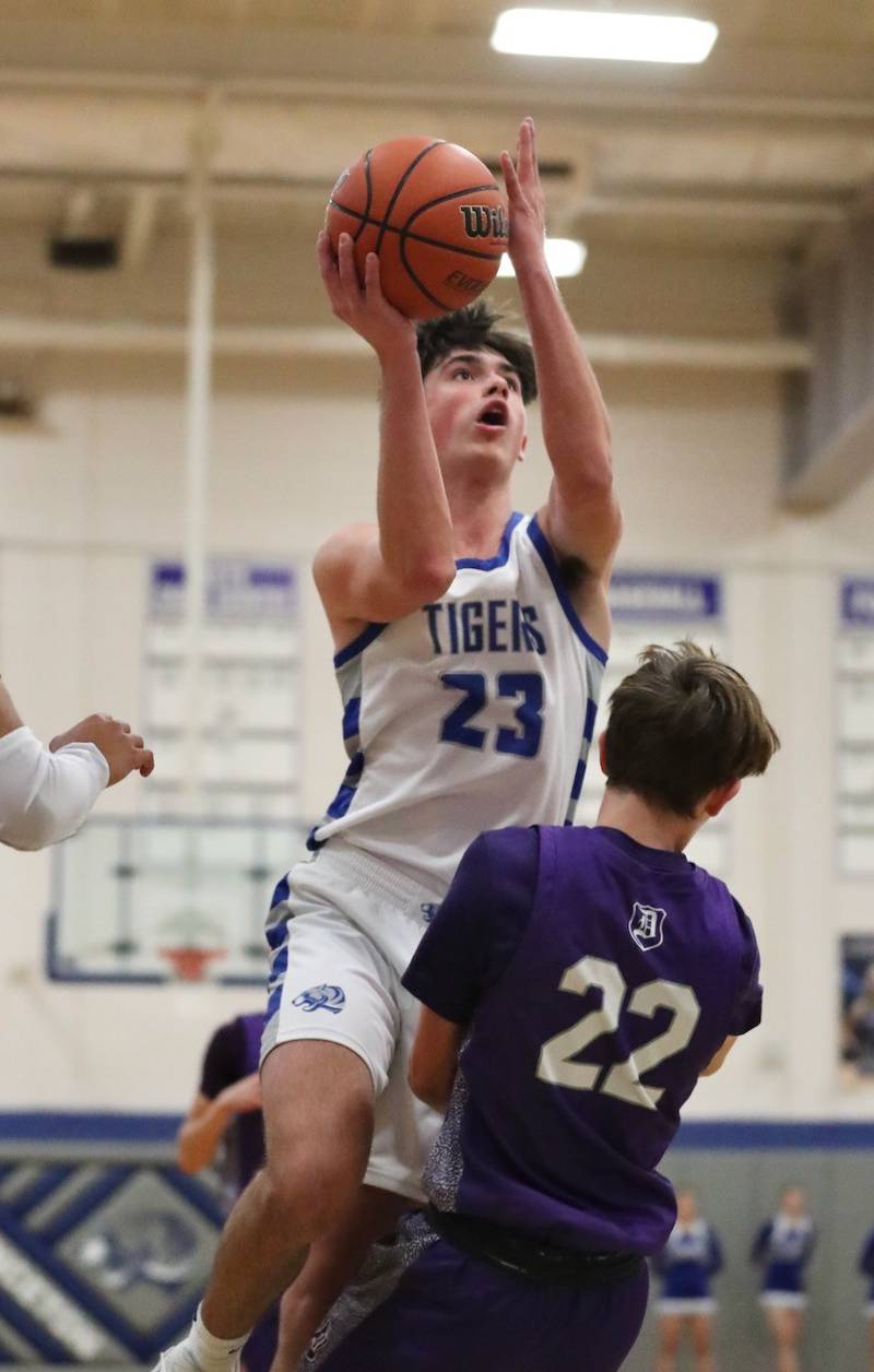 Princeton's Noah LaPorte goes over the top of Dixon's Bryce Feit for two of his game-high 24 points in the Tigers' 60-52 win Tuesday night at Prouty Gym.