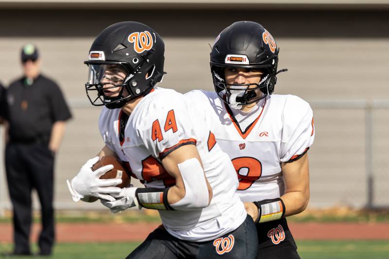 Washington's Noah Garcia hands-off to Will Freeman during a 5A varsity football playoff game against Providence at Providence on Nov. 15, 2025.