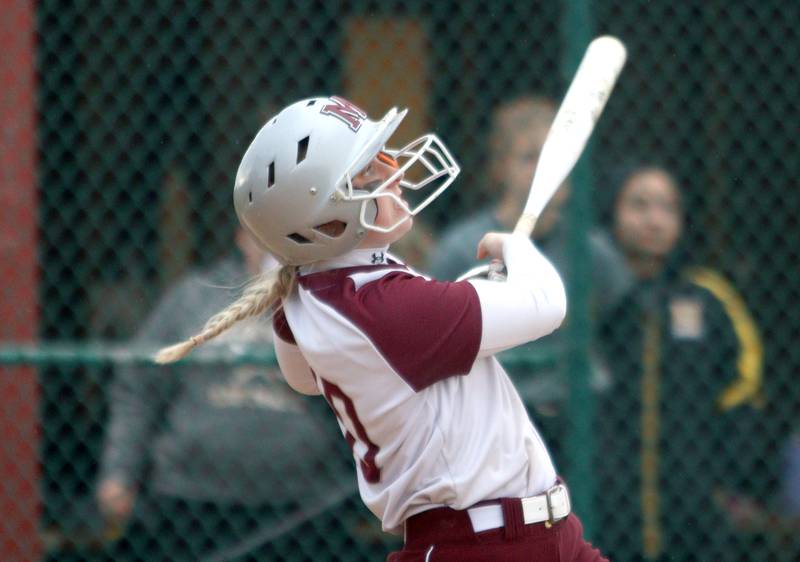 Marengo’s Lilly Kunzer homers to clinch a win against Harvard in varsity softball at Marengo Thursday.