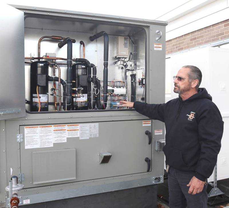 James Orr, with DeKalb School District 428 maintenance, talks Thursday, Nov. 3, 2022, about the features inside of one of the new air conditioning units on the roof of Huntley Middle School.