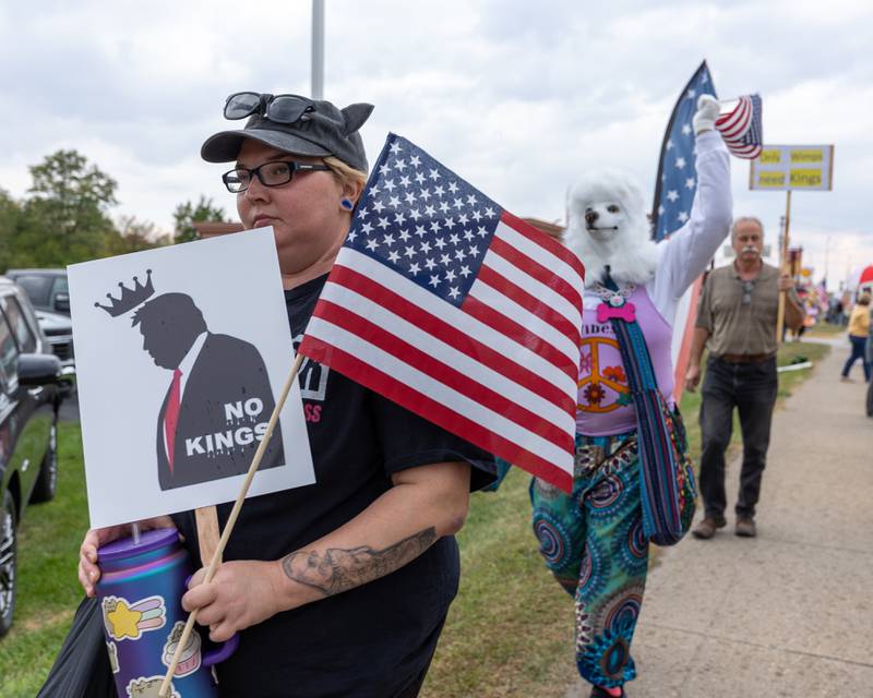 Protesters march down sidewalk at the ‘No Kings 2.0’ Protest on Saturday, October 18, 2025 on North Division Street in Morris.