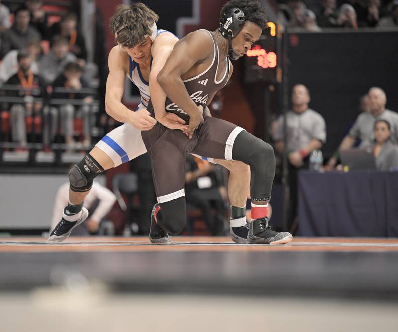 Marmion Academy’s Nicholas Garcia wrestles Joliet Catholic’s Jason Hampton in the class 3A 132-pound match at the boys IHSA wrestling finals at State Farm Center in Champaign on Saturday, Feb. 21, 2026.