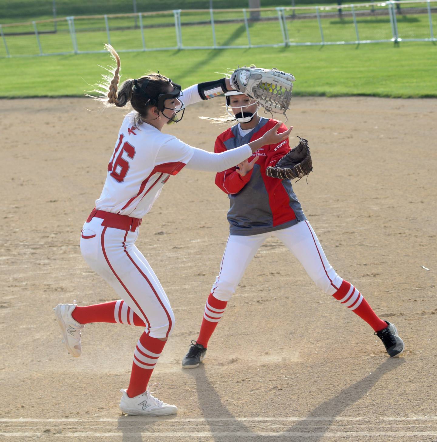 Oregon first baseman Ava Hackman (16) catches a pop fly as Haleigh Burkhart comes in to help during in a May 1 game against Stillman Valley at Oregon Park West.