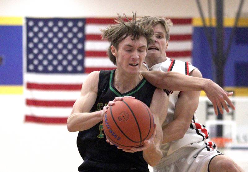 Huntley’s Carter Schaap, right, battles Crystal Lake South’s James Carlson in varsity basketball tournament title game action at Johnsburg Friday.