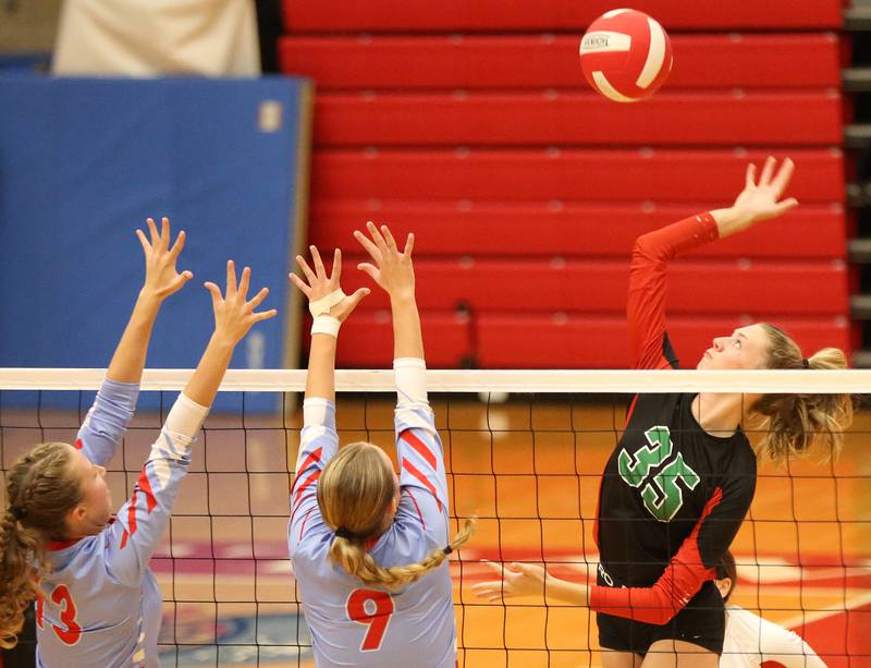 L-P's Aubrey Duttlinger hits a spike past Ottawa's Ayla Dorsey and teammate Skylar Dorsey