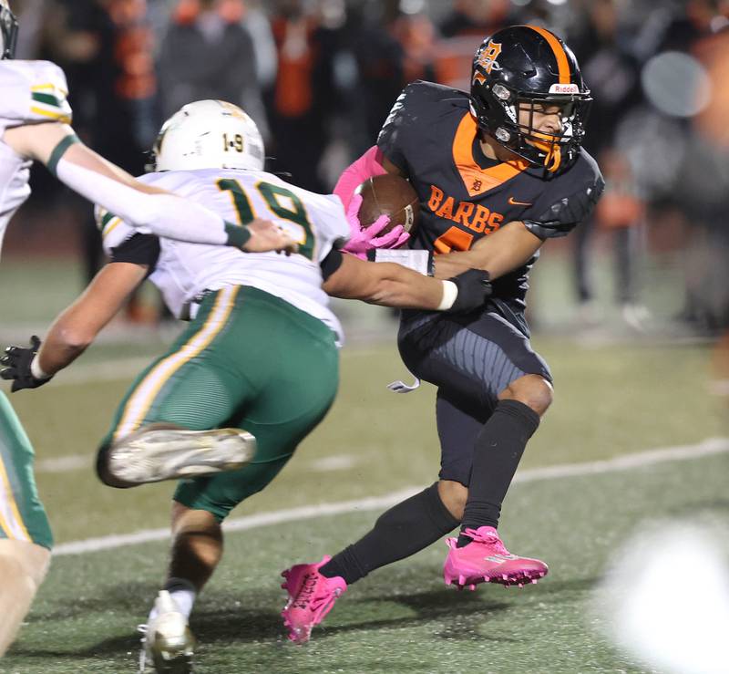 DeKalb's Xavier Dandridge breaks the tackle of Waubonsie Valley's Mason Ringenbach during their game Thursday, Oct. 20, 2022, at DeKalb High School.