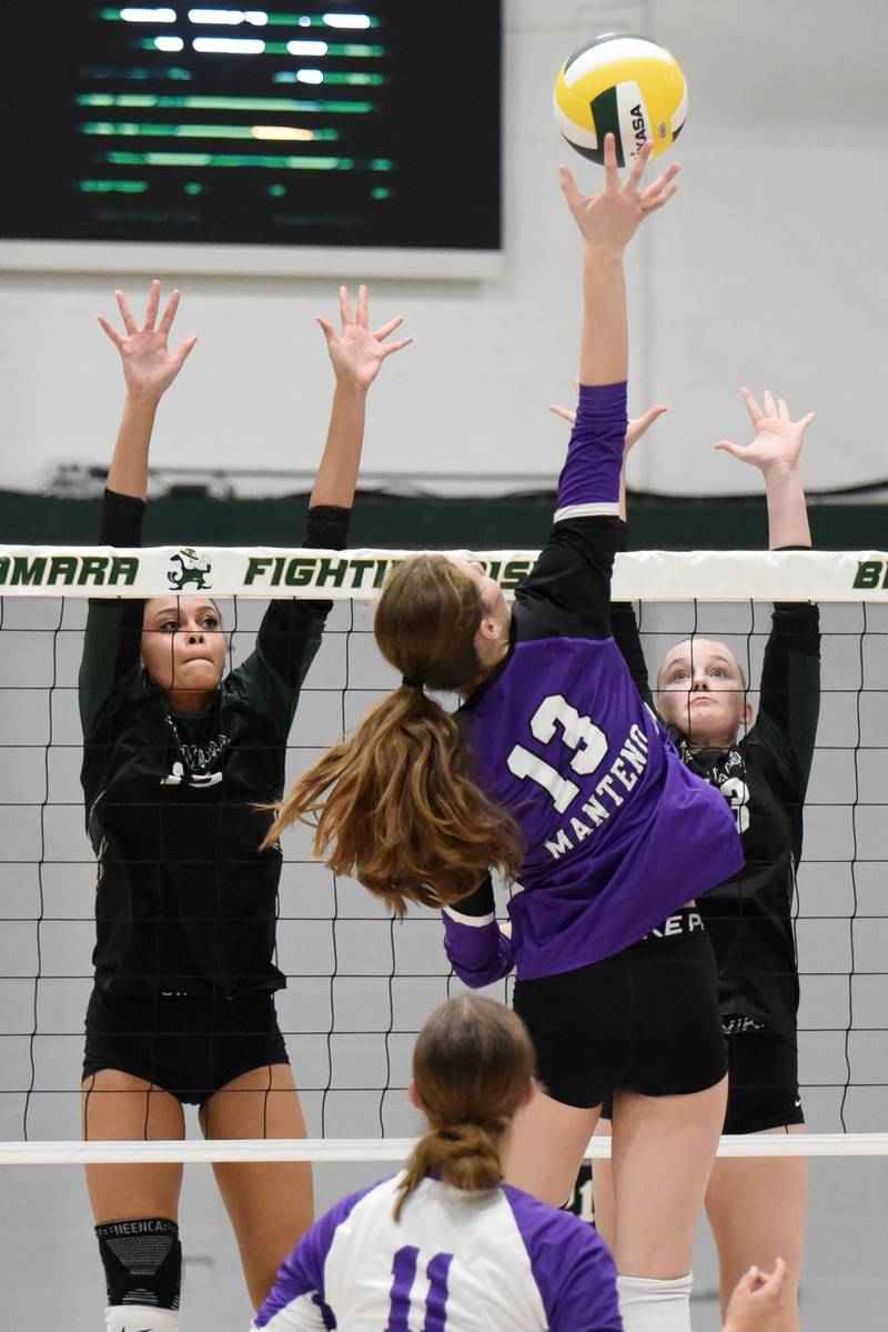 Bishop McNamara's Jersey Slone, left, and Emma Thyfaulyt, right, look to block a hit from Manteno's Olivia McElroy during a game at Bishop McNamara Monday, Oct. 20, 2025.