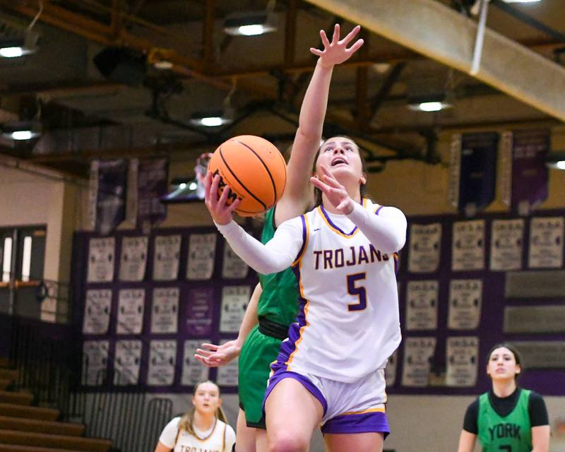 Downers Grove North's Campbell Thulin (5) makes a basket while being defended by York's Olivia Silkaitis during the game on Tuesday Dec. 3, 2024, held at Downers Grove North High School.