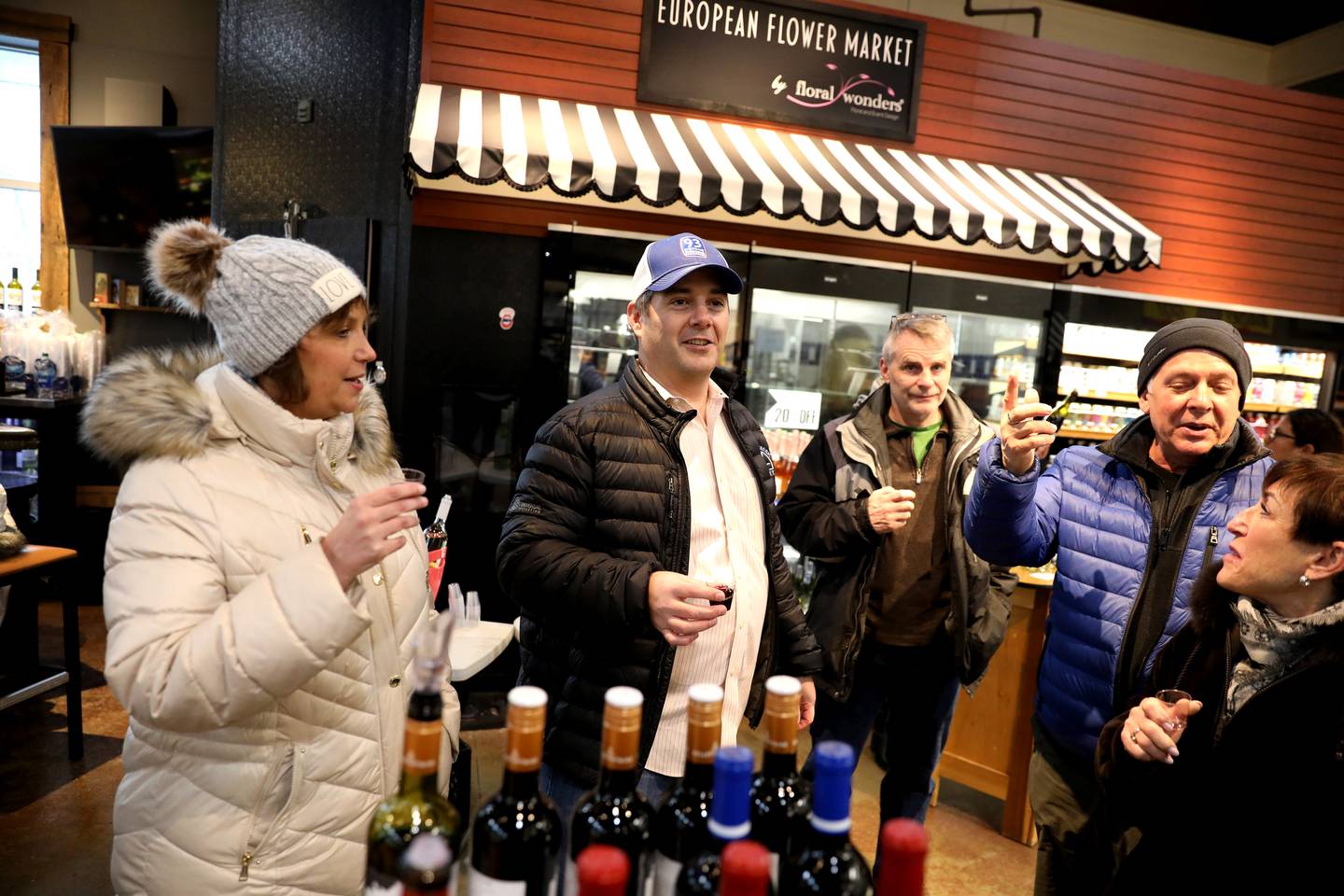 Blue Goose Market President and CEO Paul Lencioni (center) shares a toast with customers during the final wine tasting event on Thursday, Feb. 24, 2022. Lencioni announced the store was closing after more than 90 years in business in early February.