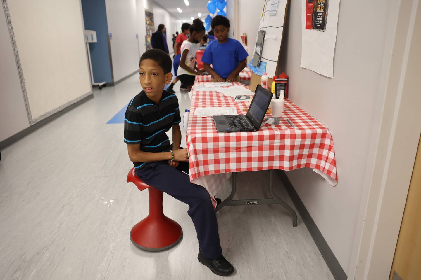 Kahlyl Jimerson promotes his barber shop at the Laraway 70C 5th Grade Business Expo. Friday, May 13, 2022, in Joliet.