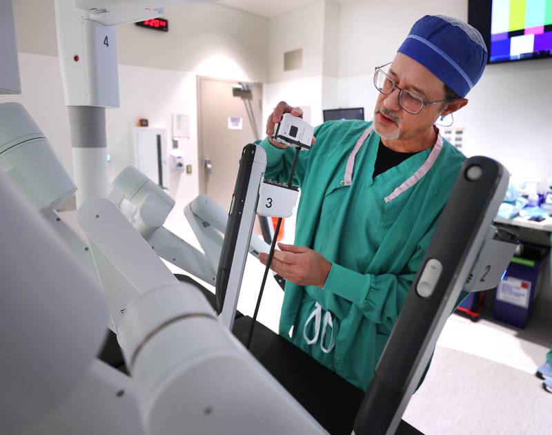 Dr. Jack Wagoner, associate chief medical officer at Northwestern Medicine Kishwaukee Hospital, slides an attachment into place on the da Vinci Xi robotic surgical system Tuesday, Oct. 28, 2025, in one of the operating rooms at the hospital in DeKalb. The hospital recently celebrated its 2,000th successful robotic-assisted surgery.