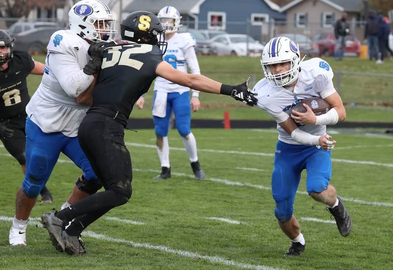 St. Francis' Seth Valeri runs just out of the reach of Sycamore's Landon Egler Saturday, Nov. 16, 2024, during their Class 5A quarterfinal game at Sycamore High School.