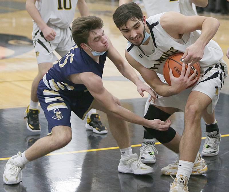 Putnam County’s Jackson McDonald, (23) grabs a rebound over Marquettes Tommy Durdan, (15) at the Tri-County Conference Tournament on Friday Jan. 28, 2022 in Granville.