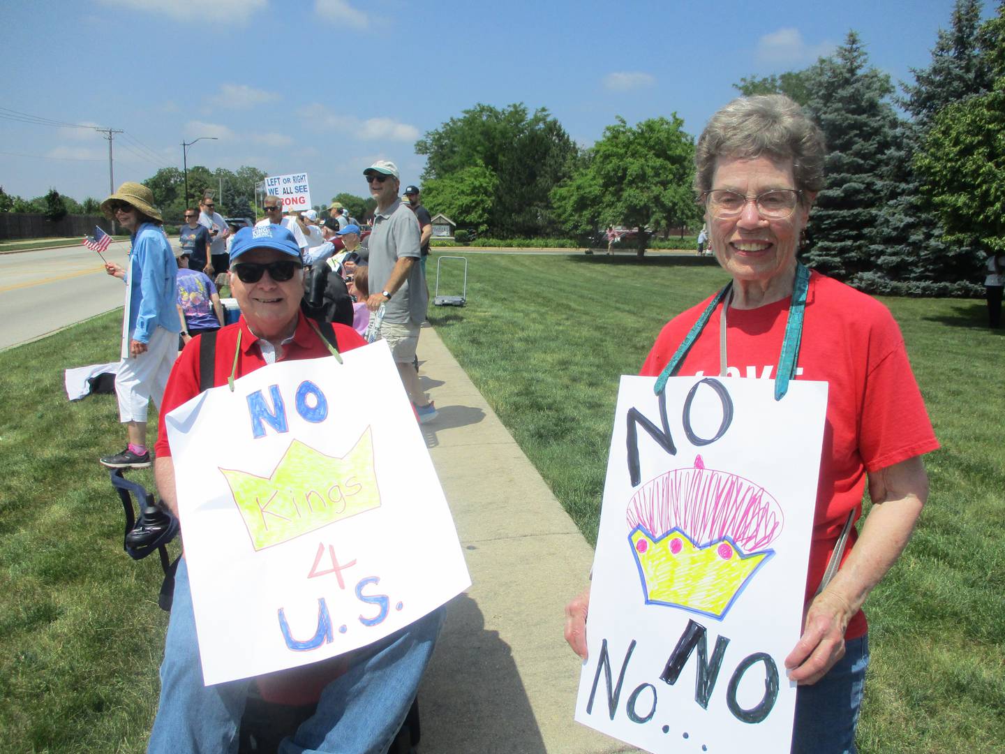 Dorothy Brumbaugh and Bob Blackburn, residents of the Timbers of Shorewood senior living senter, show their opposition to the Trump administration during a demonstration on Saturday. June 14, 2025