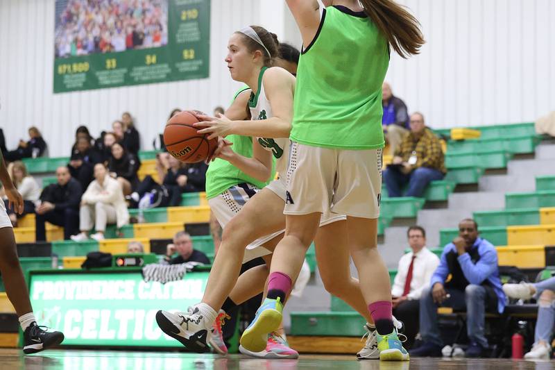Providence’s Claire Wajda passes out of the paint against IMSA in the Class 3A Providence Regional Semifinal on Tuesday, February 14th.