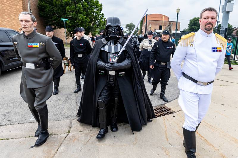 Grand Moff Tarkin, Darth Vader, and an Imperial Grand Admiral march in the Star Wars Day Parade during Joliet Public Library's event on June 7, 2025.