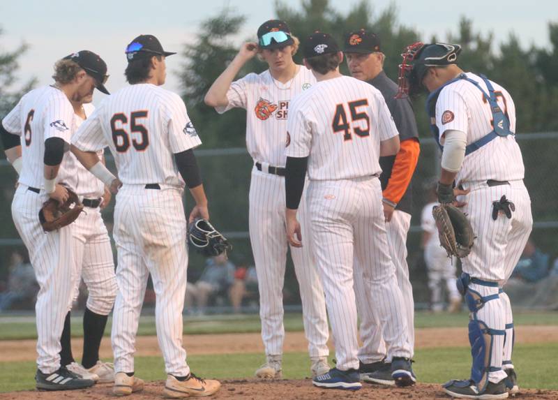 John Jakiemiec Pistol Shrimp team owner and field manager (second from right) talks to his team during opening night against the Normal Corn Belters in Schweickert Stadium on Thursday, May 30, 2024 at Veterans Park in Peru.
