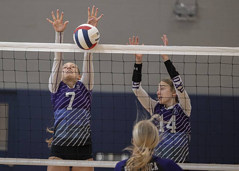 Dixon’s Makenzie Toms (left) and Leah Carlson go up to block a shot against Pecatonica at the Sterling Volleyball Invitational Saturday, Sept. 30, 2023 held at Challand Middle School.