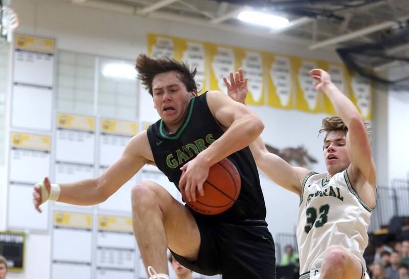 Crystal Lake South’s Cooper LePage, left, gathers a rebound in front of Grayslake Central’s Jake Kruse during Hinkle Holiday Classic Basketball Tournament title game action at Jacobs High School Friday.