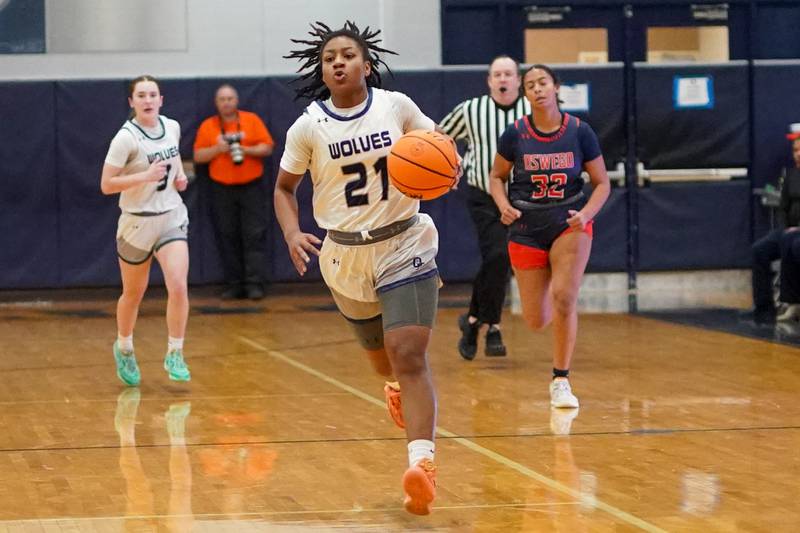 Oswego East's Desiree Merritt (21) dribbles the ball up court on a fast break against Oswego during a basketball game at Oswego East High School on Saturday, January 14, 2017.