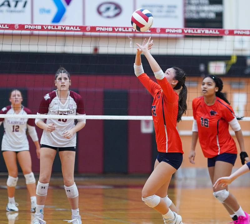 Oswego’s Ava Flanigan (12) sets the ball against Plainfield North during the class 4A Plainfield North regional volleyball final at Plainfield North High School on Thursday, Oct. 26, 2023.