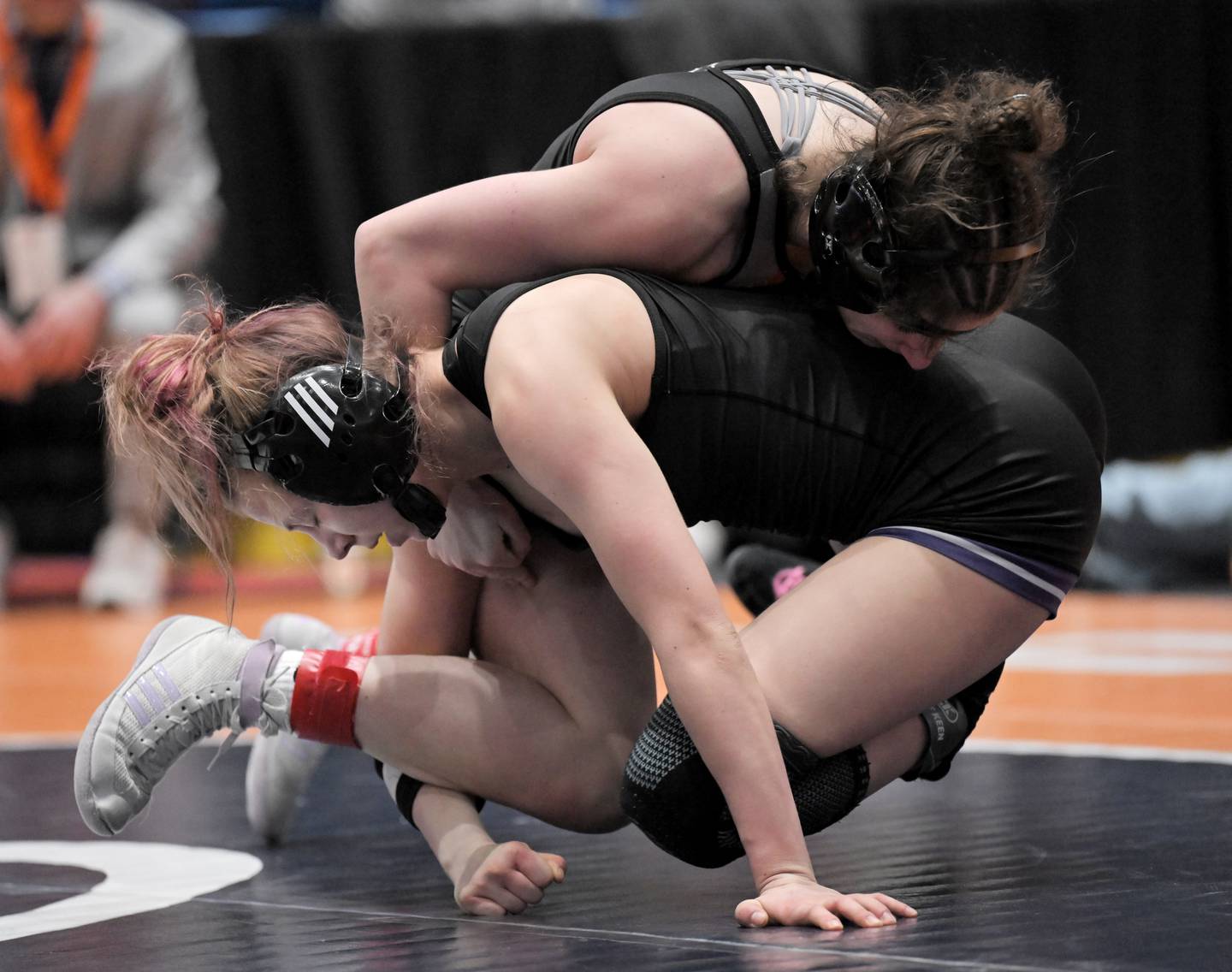 Kaneland’s Angelina Gochis controls Hampshire’s Amelia Nidelea-Polanin in the 120-pound class at the girls wrestling state finals tournament at Grossinger Arena in Bloomington on Saturday, Feb. 28, 2026.