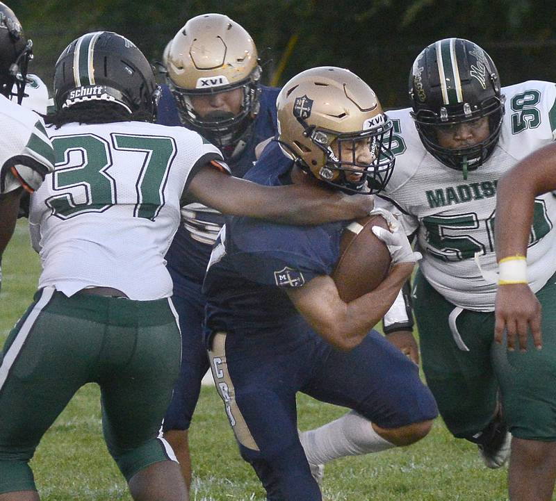 Marquette’s Payton Gutierrez works to break through the madison defense on a run Friday in the 1st quarter at Marquette.