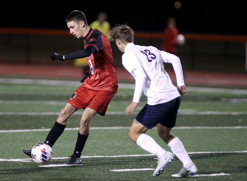Glenbard East’s Zachary Pfister (right) keeps the ball away from Conant’s AJ Baran during a 3A St. Charles East Sectional semifinal on Wednesday, Oct. 26, 2022.