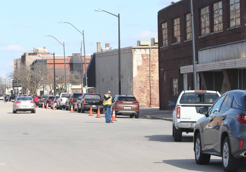 Cars wait in line for carryout meals on Wright Street during the 24th annual Lighted Way Spaghetti dinner on Monday, March 27, 2023 in La Salle.