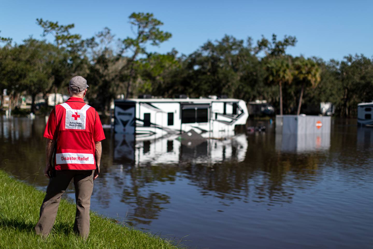 September 26, 2022. Wauchula, Florida
Red Cross volunteer Dave Wagner surveys the Peace River RV and Camping Resort in Wauchula, Fl., the day after Hurricane Ian ravaged the state. Dangerous conditions persisted and flood waters continued to rise as the swollen Peace River covered sections of Hwy 17, a major north/south thoroughfare. 
Photo by Marko Kokic/American Red Cross
