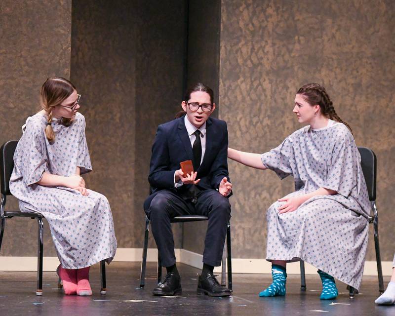 Daniel Nunez plays the character named Death, center, chats with Sam played by Ginn Gibbs, right and Ann played by Joanna Barcelona during a therapy scene one act of the play of Cheating Death on Saturday March 22, 2025, held at Lyons Township High School south campus.