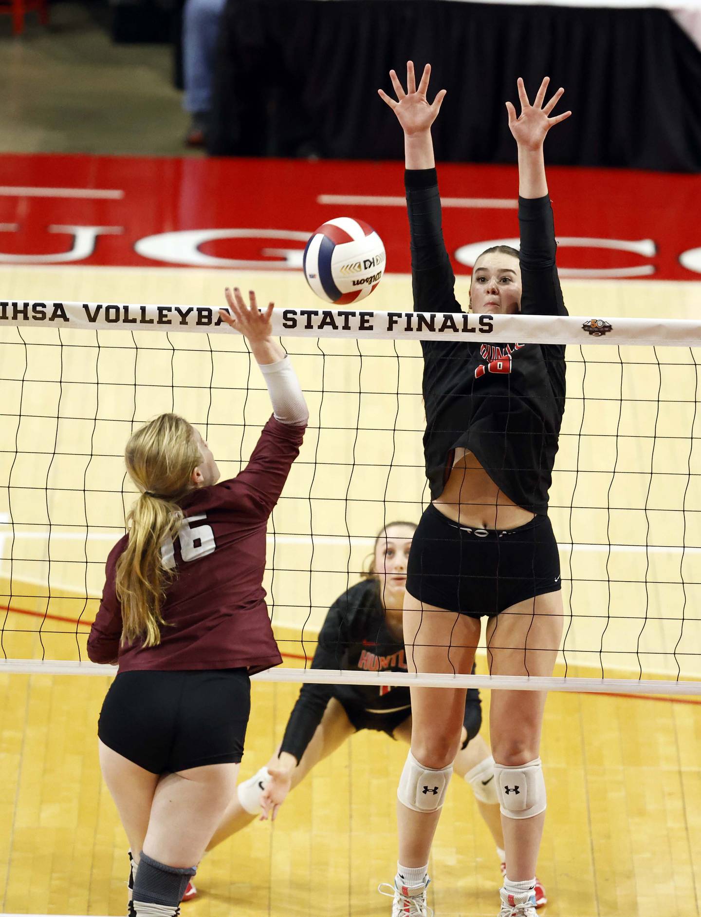 Lockport's Quinn Higham (16) tries to push the ball past Huntley's Georgia Watson (16) during the IHSA Class 4A girls volleyball third place match Saturday, Nov. 16, 2024 at CEFCU Arena in Normal.