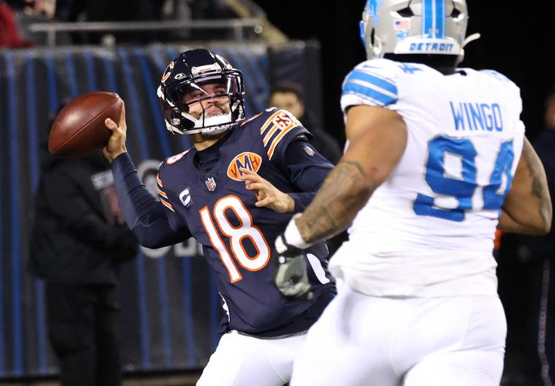 Chicago Bears quarterback Caleb Williams heaves the ball downfield ahead of the pressure of Detroit Lions defensive tackle Mekhi Wingo during their game Sunday, Jan. 4, 2026, at Soldier Field in Chicago.