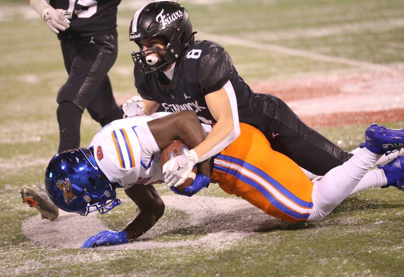 Fenwick's Jake Theis tackels East St. Louis running back Myson Johnson-Cook during the Class 6A State championship game on Tuesday, Dec. 2, 2025 in Hancock Stadium at Illinois State University in Normal.