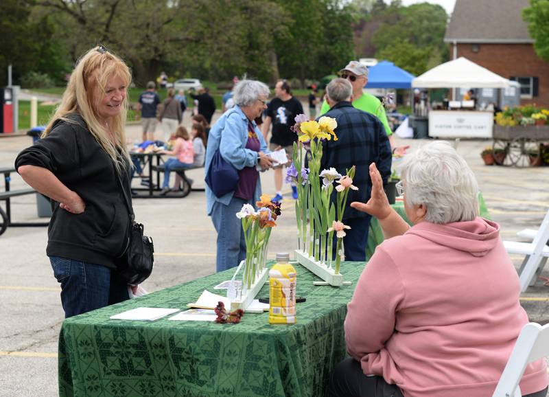 Deanna Riha of Willowbrook talks with Northern Illinois Iris Society member Pat Olsen while attending Cantigny's Spring Fling and Market Saturday May 13, 2023.