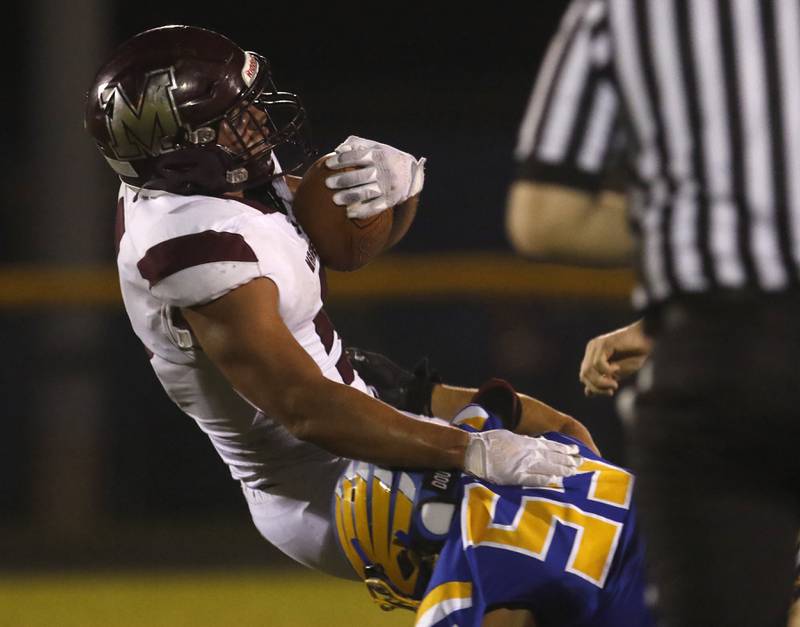 Marengo’s Isaac Anthony tries to spin out of the tackle of Johnsburg's Cody Ferrari during a Kishwaukee River Conference football game on Friday, Sept. 15, 2023, at Johnsburg High School.