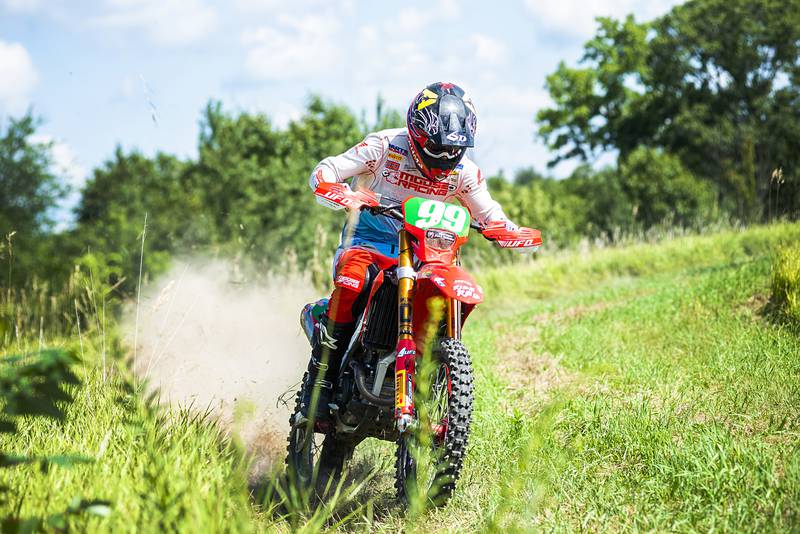 Cody Barnes hits the throttle after coming out of a turn Thursday, August 4, 2022 while training on a course near Fenton. Barnes will be traveling overseas later this month to participate in an international motocross competition.