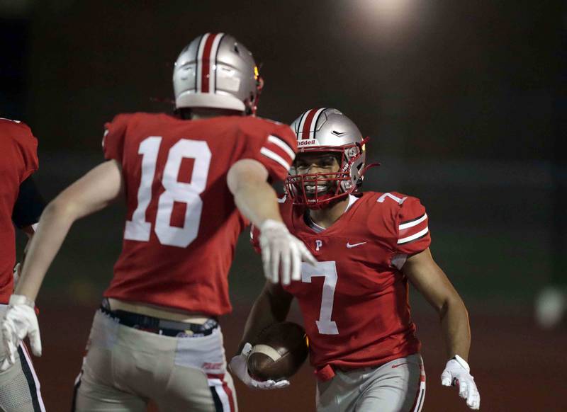 Palatine's Dominik Ball  (7) celebrates his first touchdown with teammate Palatine's Ryan Donnelly (18) against Hoffman Estates Friday October 21, 2022 in Palatine.