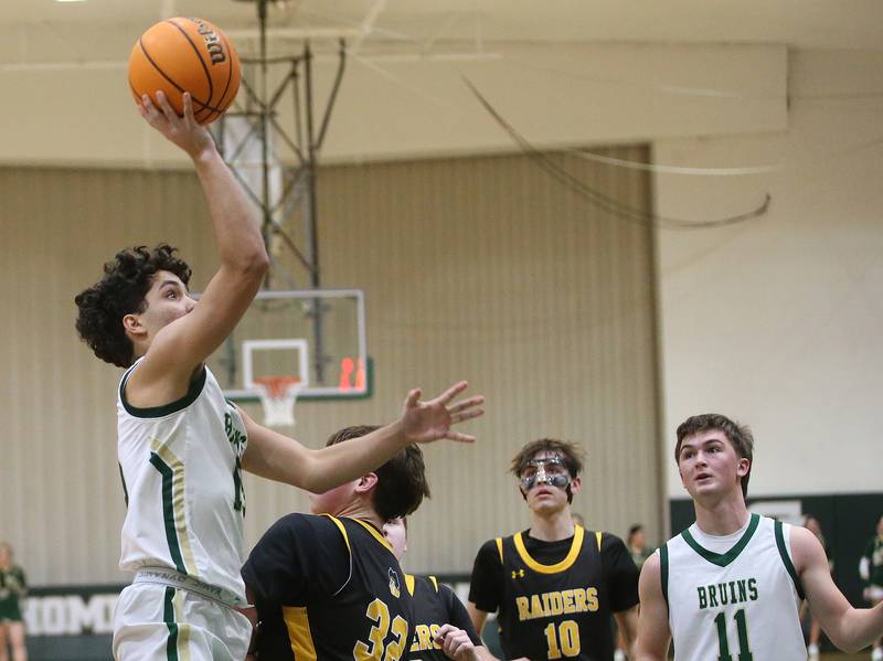 St. Bede's Jose De La Torre eyes the hoop while taking a shot over Ashton-Franklin Center's Nolan Rueff during the Class 1A Regional quarterfinal game on Monday, Feb. 24, 2025 at St. Bede Academy.