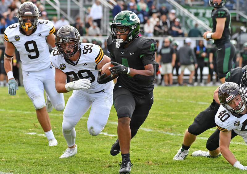 Glenbard West’s Chase Cavan and Jaylen McMiller (9) celebrate McMiller’s kick return for touchdown during a game against Joliet Catholic on September 6, 2025 at Glenbard West High School in Glen Ellyn.