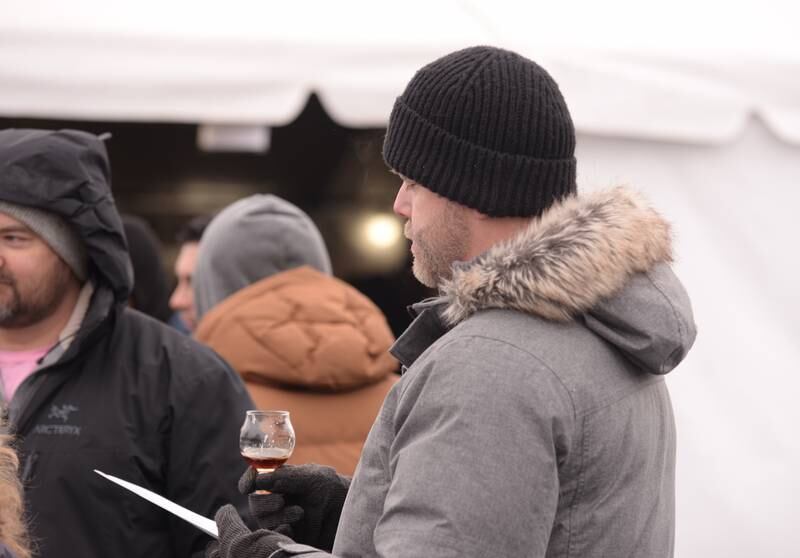 Joe Dawson of Park Ridge looks over the beer list while attending the Westmont Park District's Winter Beer Festival Saturday, Feb. 15, 2025.