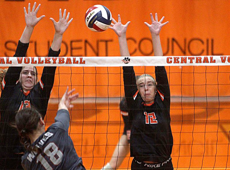 Crystal Lake Central’s Siena Smiejek, left, and Olivia Doppke, right, block against Prairie Ridge in varsity volleyball at Crystal Lake Central Thursday night.