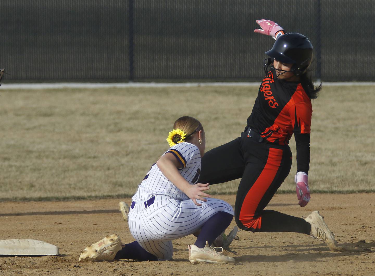 Crystal Lake Central's Logan Grams slides into second base as Wauconda's Ainsleigh Buse tries to tag her during a nonconference softball game on Friday, March 20, 2026, at Crystal Lake Central High School.