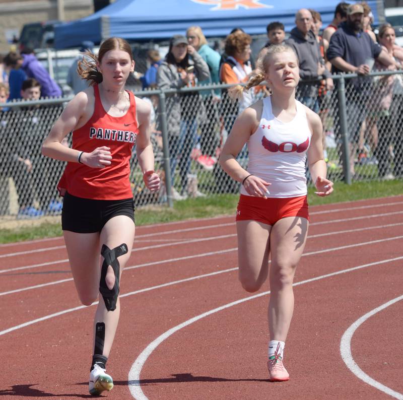 Erie-Prophetstown's Sarah Link (left) and Oregon's Madeline Rogers run the 800 meters at the Gebhardt-Worley Invitational at Oregon High School on Saturday, April 12, 2025. Link finished second in the event and Rogers was fourth.