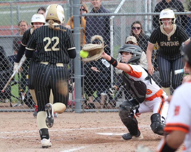 Sycamore's Annabella Johnson scores as DeKalb's Madison Hallaron catches the ball Friday, May 2, 2025, during their game at DeKalb High School. Latimer was injured on the play.